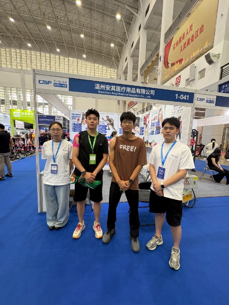 Members of the Anqi Medical team pose in front of the company's sports tape booth during the Ningbo Sporting Goods Expo.